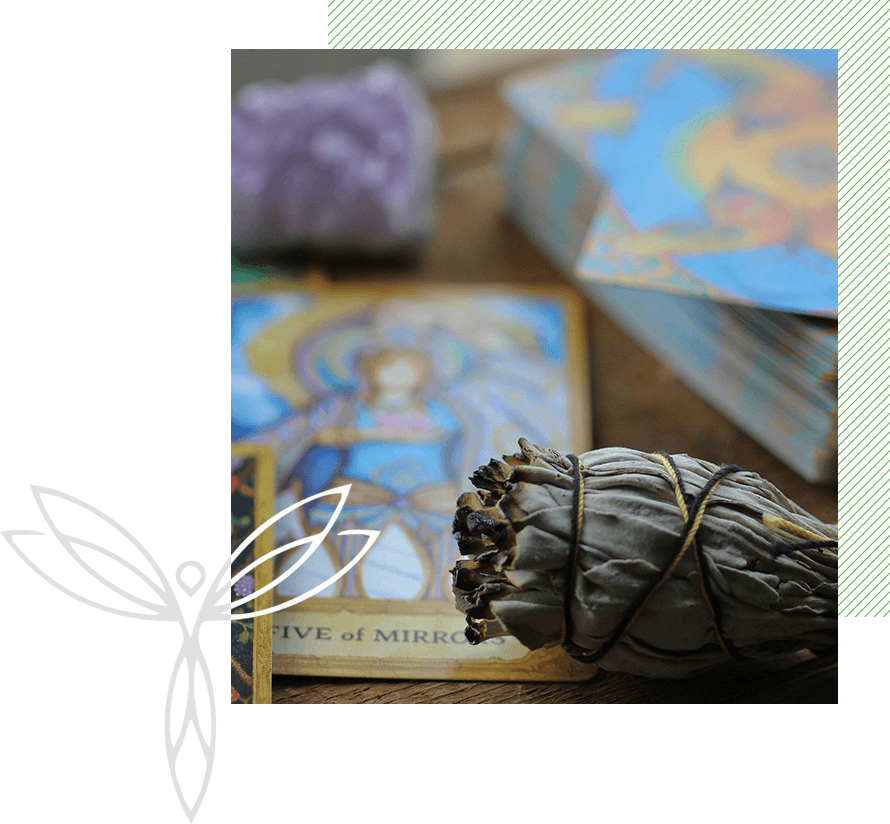 A close up of a bundle of sage and cards