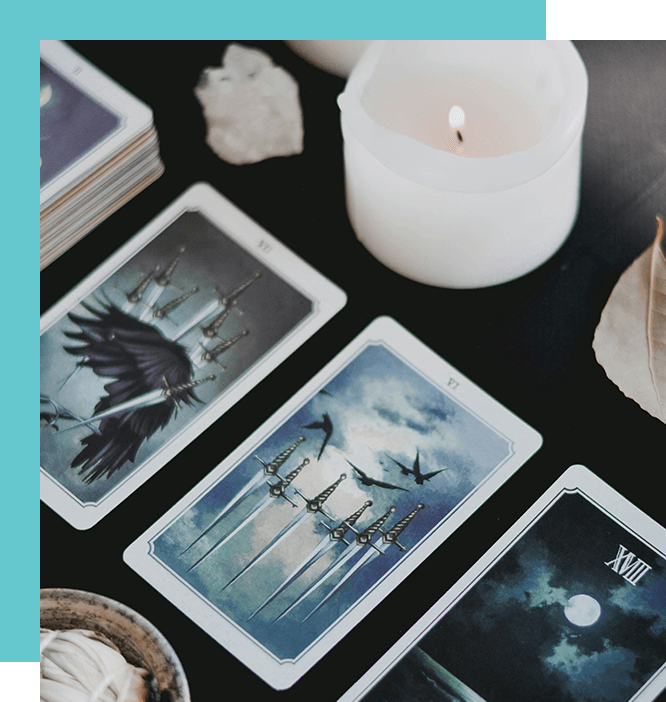 A table with tarot cards and candles on it.