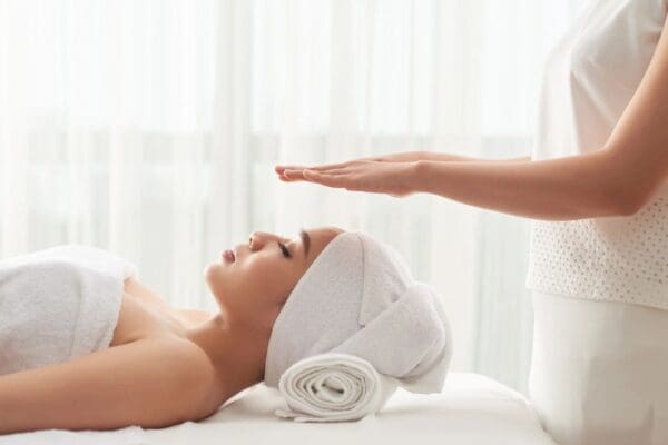 A woman getting her face washed by a masseuse.