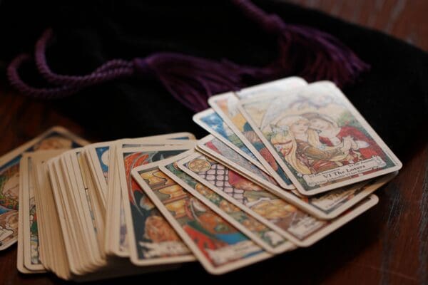 A pile of tarot cards sitting on top of a table.