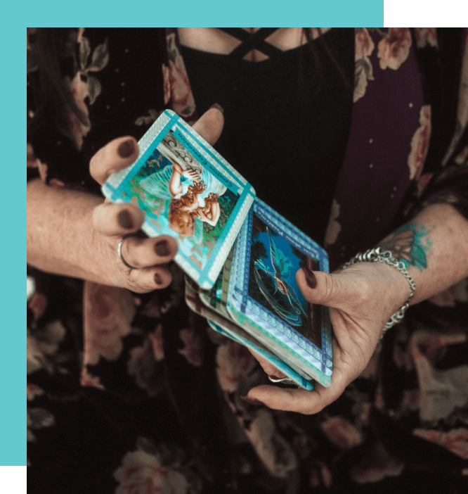 A woman holding two stacks of cards in her hands.